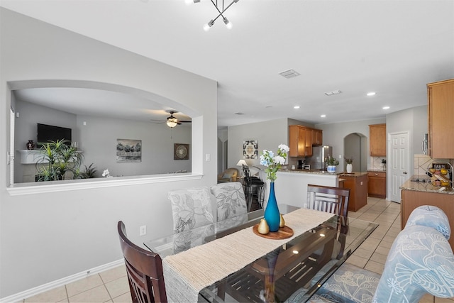 dining space with ceiling fan and light tile patterned floors