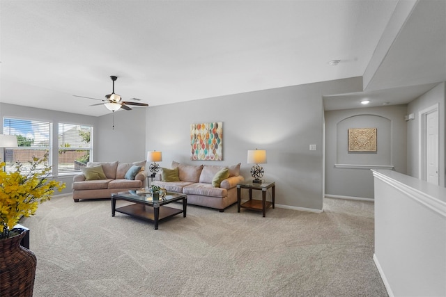 carpeted living room featuring ceiling fan