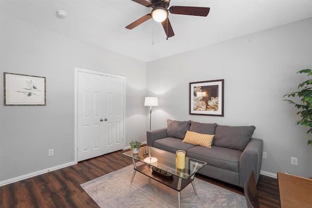 living room with dark hardwood / wood-style flooring and ceiling fan