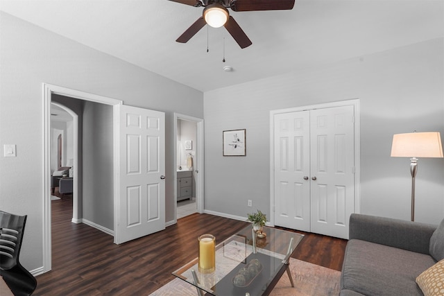 living room with ceiling fan and dark hardwood / wood-style floors