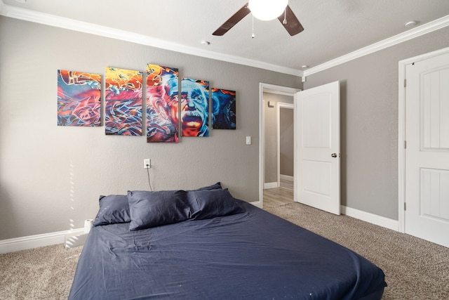 carpeted bedroom with ceiling fan and crown molding