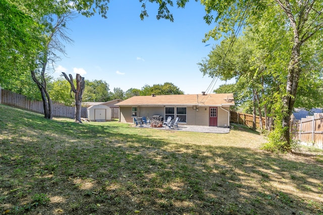 back of house with a shed, a yard, and a patio area