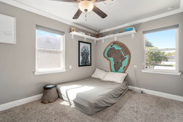 bedroom with ornamental molding, ceiling fan, and carpet floors