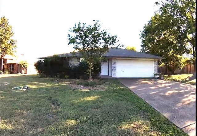 ranch-style home with a garage and a front yard