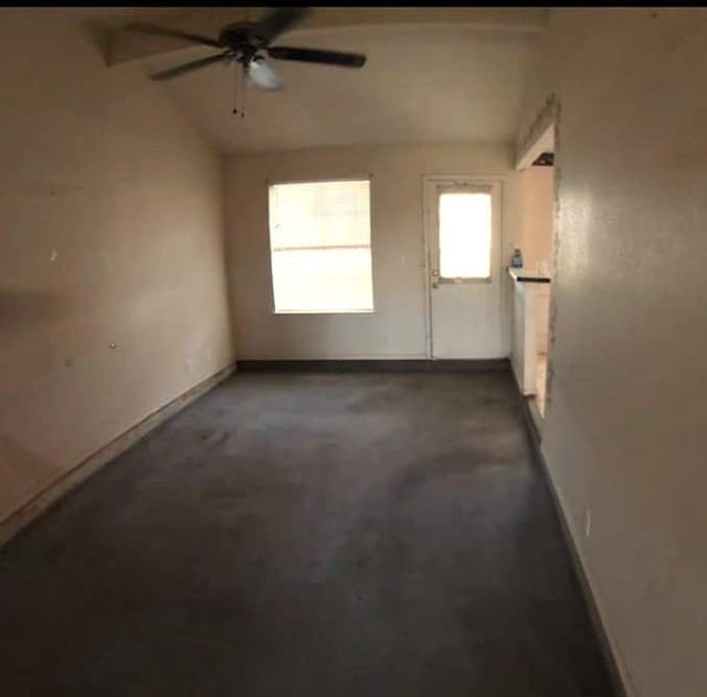 spare room featuring vaulted ceiling and ceiling fan