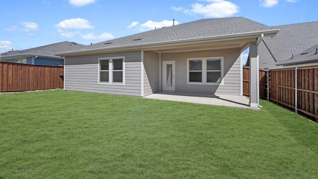 view of front of home with a garage and a front lawn