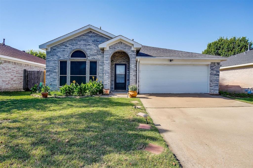 ranch-style house with a front yard and a garage