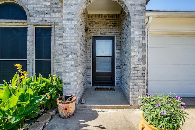 view of exterior entry featuring a garage