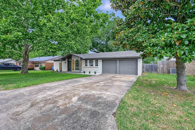 ranch-style house featuring a garage, a front lawn, and central AC