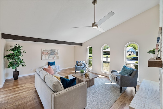 living room with ceiling fan, high vaulted ceiling, and light hardwood / wood-style flooring