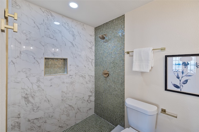 bathroom with toilet and tiled shower