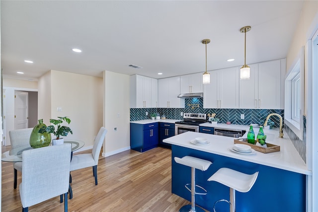 kitchen featuring blue cabinetry, sink, white cabinetry, hanging light fixtures, and appliances with stainless steel finishes