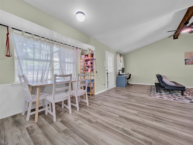 dining area featuring light hardwood / wood-style floors and lofted ceiling