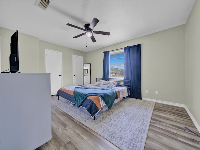 bedroom featuring light wood-type flooring and ceiling fan