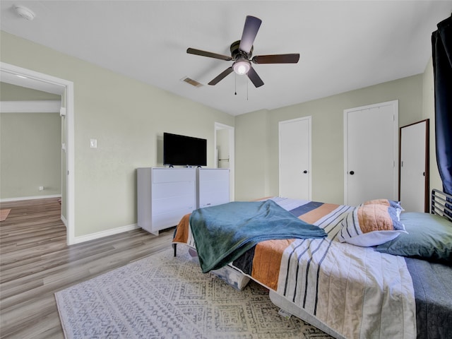 bedroom with light wood-type flooring and ceiling fan