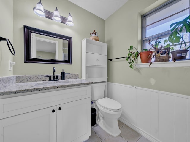 bathroom featuring tile patterned flooring, vanity, and toilet