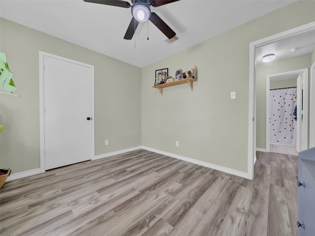 unfurnished room with light hardwood / wood-style flooring and ceiling fan