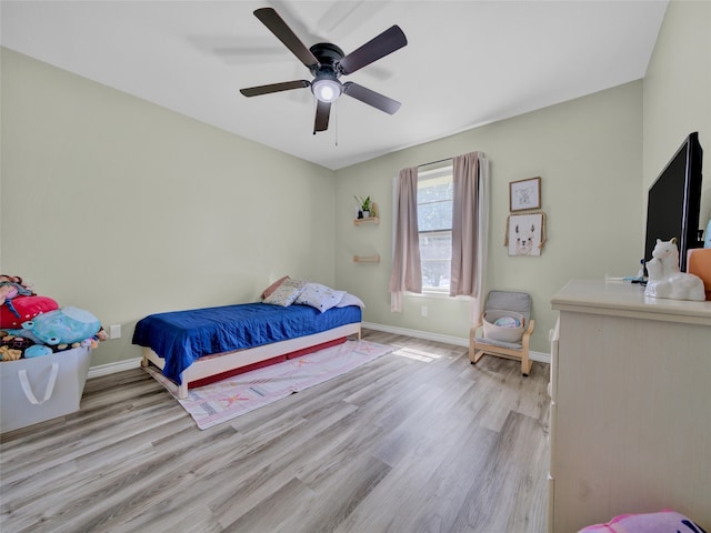 bedroom with ceiling fan and light hardwood / wood-style floors