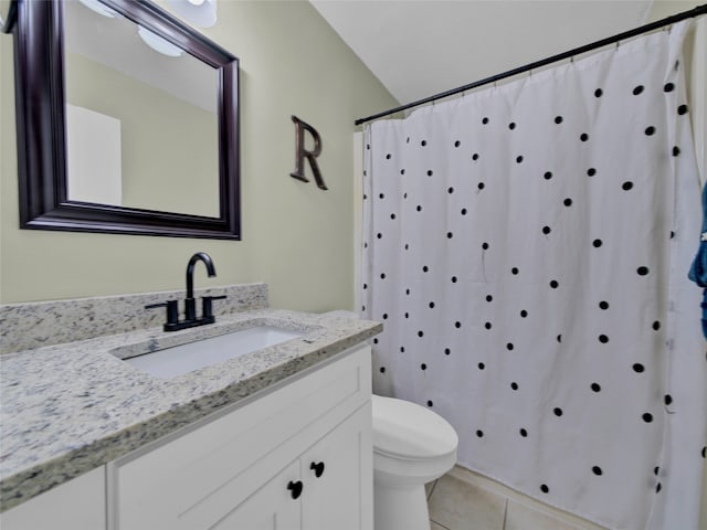 bathroom featuring curtained shower, tile patterned flooring, vanity, and toilet