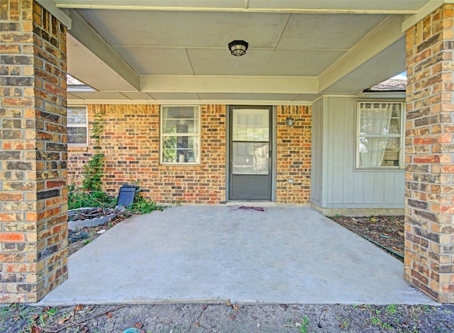 view of exterior entry featuring a patio