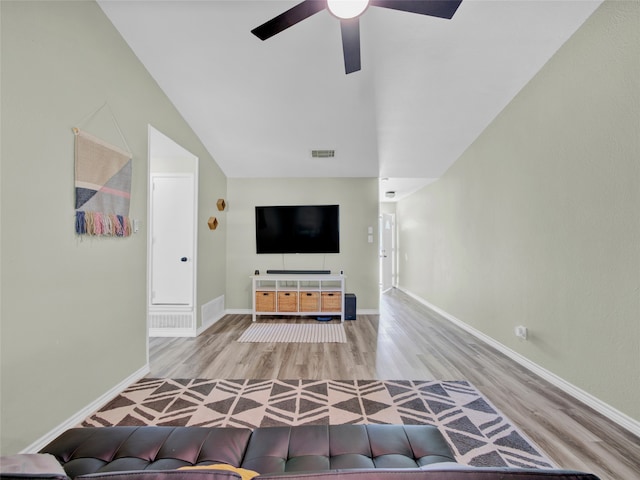 unfurnished living room with wood-type flooring, vaulted ceiling, and ceiling fan