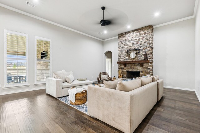 living room with ceiling fan, a fireplace, crown molding, and dark hardwood / wood-style floors