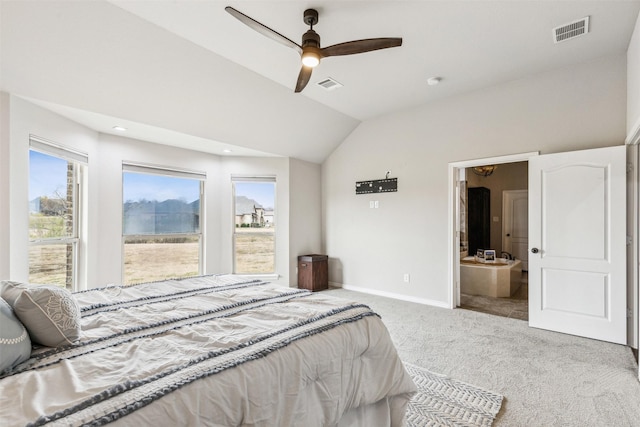 bedroom featuring connected bathroom, ceiling fan, light colored carpet, and lofted ceiling