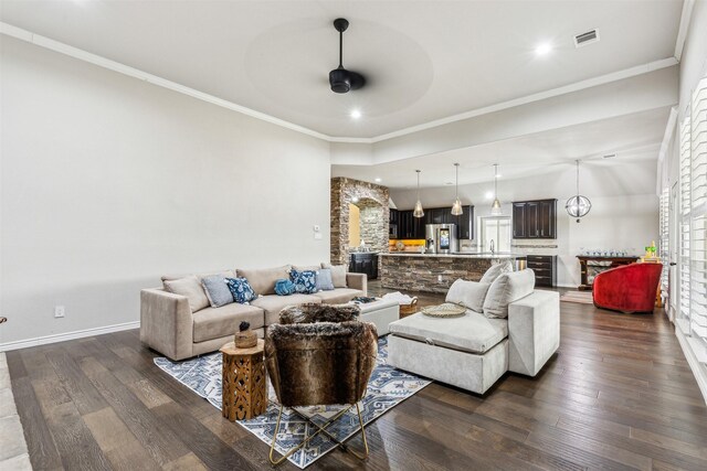 living room featuring beverage cooler, dark hardwood / wood-style floors, ceiling fan, and ornamental molding