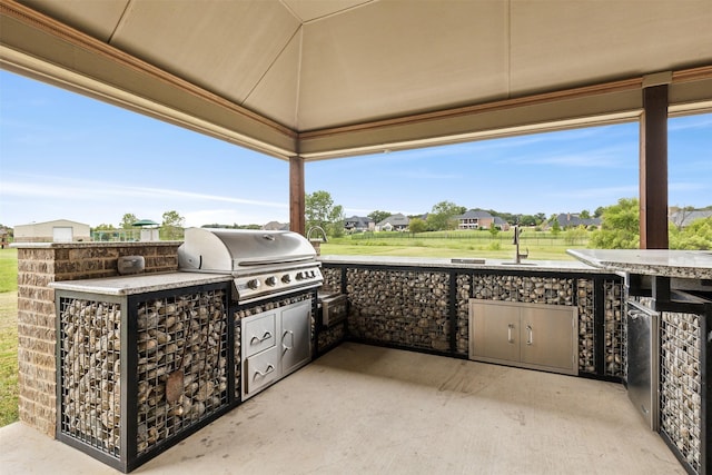 view of patio with exterior kitchen and grilling area