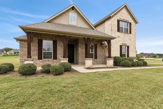 view of front of property featuring covered porch and a front yard