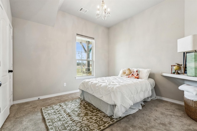 carpeted bedroom with a notable chandelier