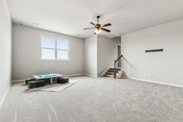 misc room featuring light colored carpet and ceiling fan