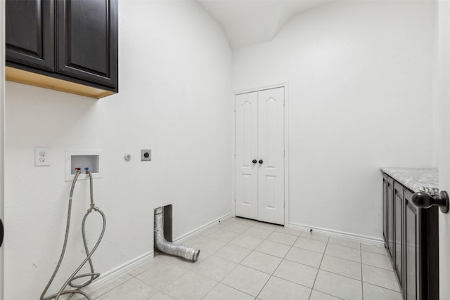 washroom with washer hookup, light tile patterned flooring, cabinets, and hookup for an electric dryer