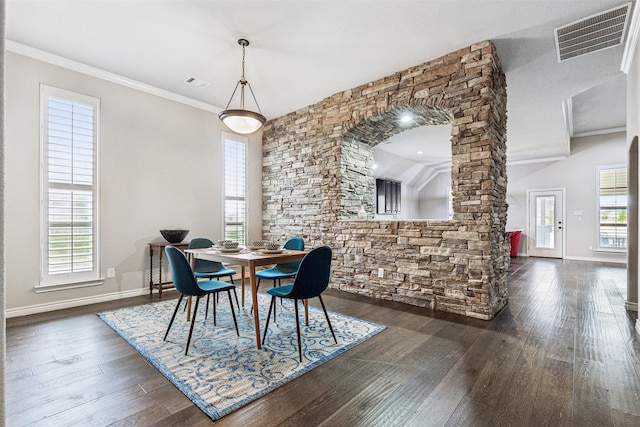 dining area featuring a healthy amount of sunlight, dark hardwood / wood-style flooring, lofted ceiling, and crown molding