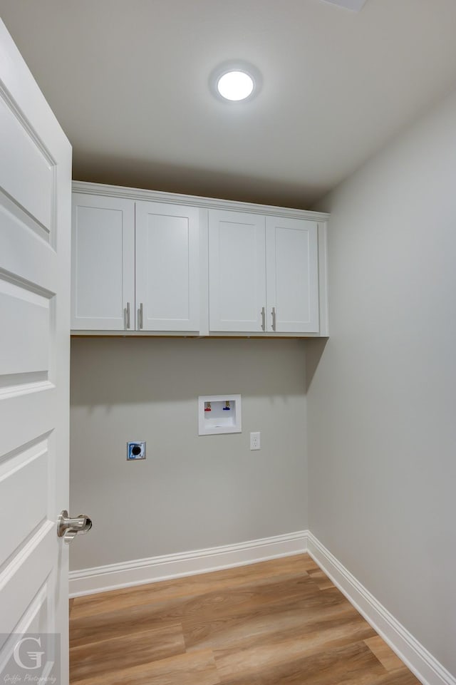 laundry area with cabinets, washer hookup, light hardwood / wood-style floors, and electric dryer hookup