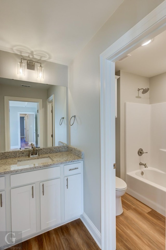 full bathroom with shower / bath combination, vanity, toilet, and wood-type flooring