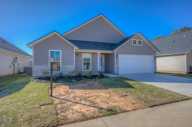 view of front of property with central AC unit, a garage, and a front yard