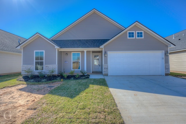 view of front of property featuring a garage and a front lawn