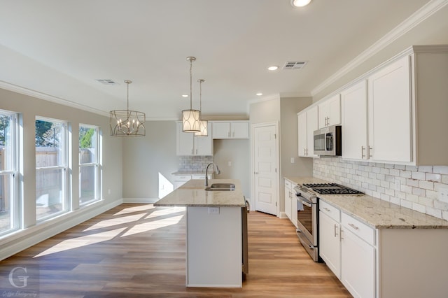 kitchen featuring white cabinetry, sink, an island with sink, and stainless steel appliances