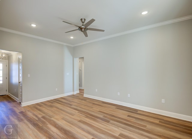 empty room featuring light hardwood / wood-style flooring, ceiling fan, and crown molding