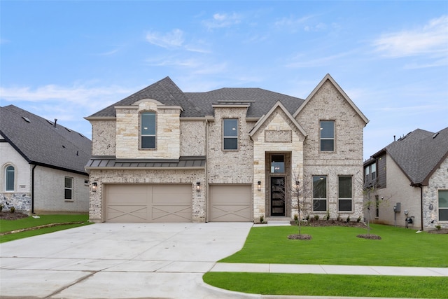 french provincial home with a garage and a front lawn