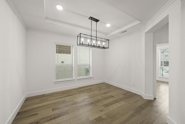 1406 Chickadee Dr, Mansfield, TX 76063 - unfurnished dining area with a tray ceiling, a chandelier, wood finished floors, and ornamental molding