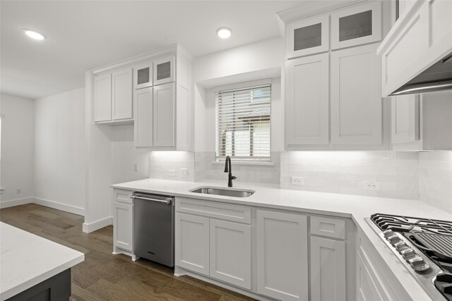 kitchen featuring dark hardwood / wood-style floors, white cabinetry, sink, and premium range hood