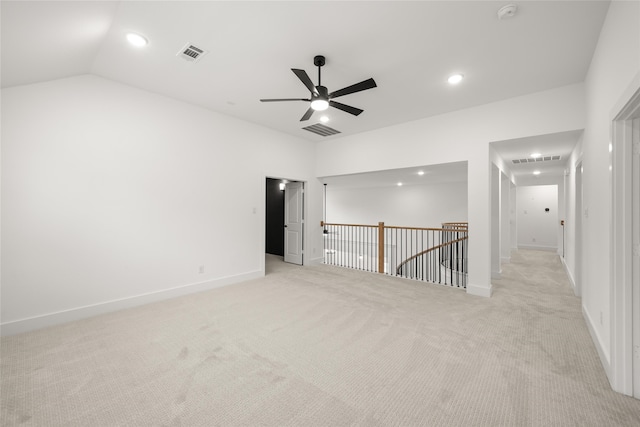 unfurnished room featuring light carpet, ceiling fan, and vaulted ceiling