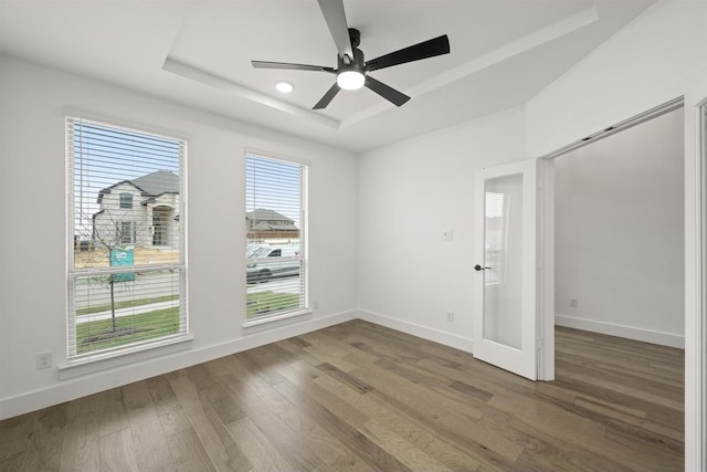1406 Chickadee Dr, Mansfield, TX 76063 - unfurnished room featuring a tray ceiling, a ceiling fan, and wood finished floors