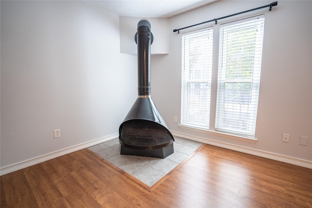 interior details featuring hardwood / wood-style flooring and a wood stove