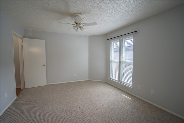 empty room featuring carpet flooring, a textured ceiling, and ceiling fan