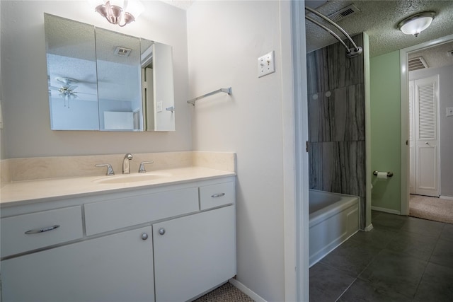 bathroom featuring shower / bath combination, tile patterned floors, vanity, a textured ceiling, and ceiling fan