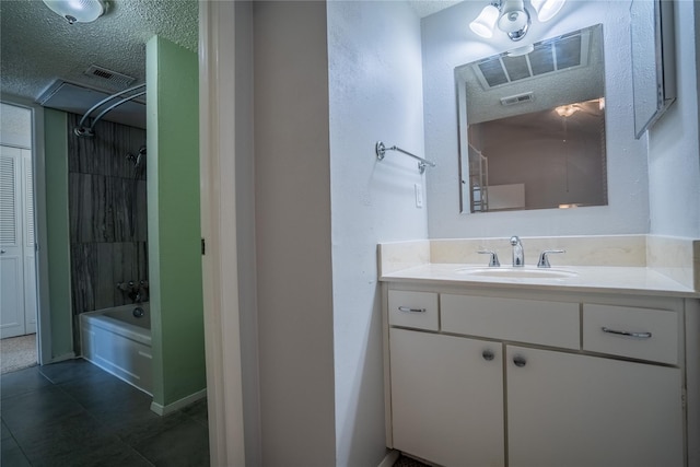 bathroom with vanity, shower / bathing tub combination, and a textured ceiling