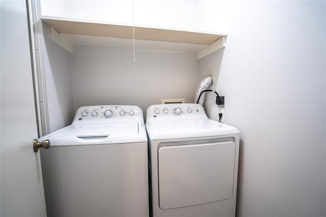 clothes washing area featuring washer and dryer